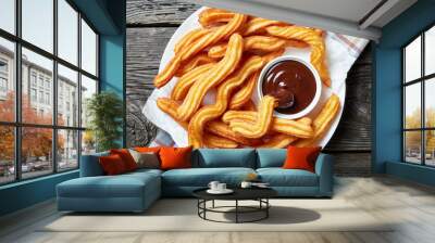 close-up of churros on plate with chocolate sauce Wall mural