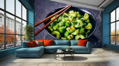 Smashed Cucumber salad in a black bowl Wall mural