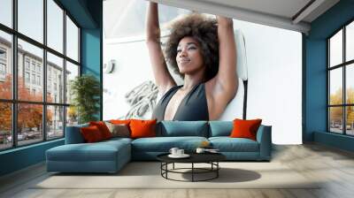 Attractive afro american girl on a yacht at summer day Wall mural