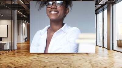 Close up portrait of young black woman laughing against white ba Wall mural