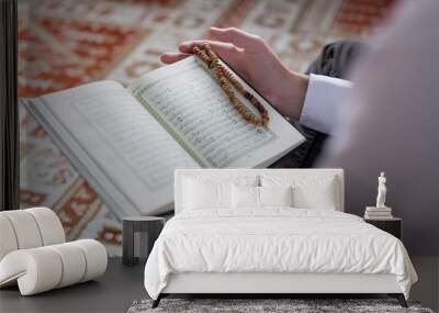 Koran in hand - holy book of Muslims ( public item of all muslim Wall mural