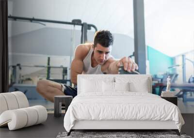 Male fitness model doing sit ups and crunches exercising abdomin Wall mural