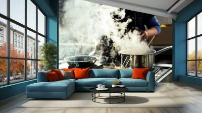 Chef cooking soup and water evaporating from a pot at a restaurant kitchen Wall mural