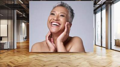 Face, beauty and skincare with a senior woman in studio on a gray background happy with an antiaging treatment. Wellness, cosmetics and skin with a mature female inside to promote natural facial care Wall mural