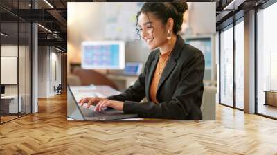 Happy businesswoman in office, typing on laptop and planning online research for creative project at digital agency. Internet, website and networking, woman with smile and computer for email review. Wall mural