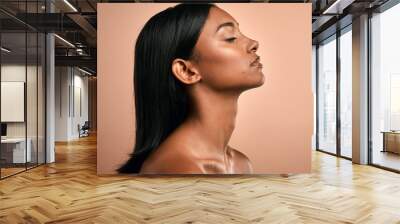 Love yours. Side shot of a beautiful young woman posing against a brown background. Wall mural