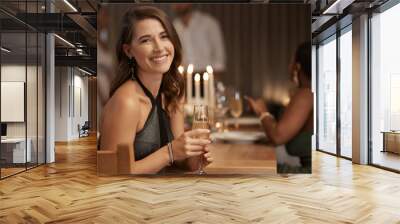 Party, celebration and portrait of a woman with champagne at a new year dinner at restaurant. Happy, smile and lady sitting at dining table with glass of wine to celebrate at festive event at a house Wall mural