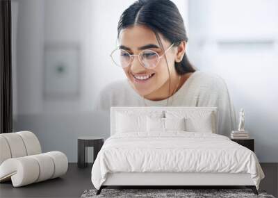 Work your way towards great results. a young businesswoman working on a laptop in an office. Wall mural