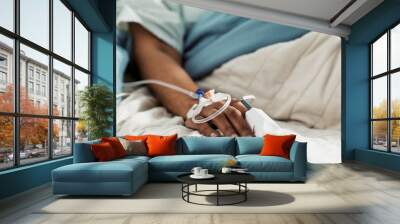 Iv drip, emergency and hand of patient in a hospital after surgery, treatment and operation in a clinic sleeping. Closeup, healthcare and person in medical ER for recovery, life support and medicine Wall mural