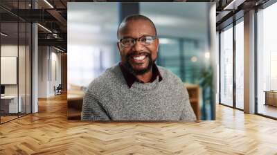 The smile of success. Cropped portrait of a handsome mature businessman sitting alone and working in his office late at night. Wall mural