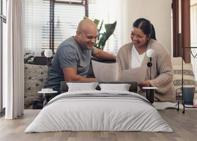 Youd be smiling too if you saved like they did. Shot of a young couple going over paperwork at home. Wall mural