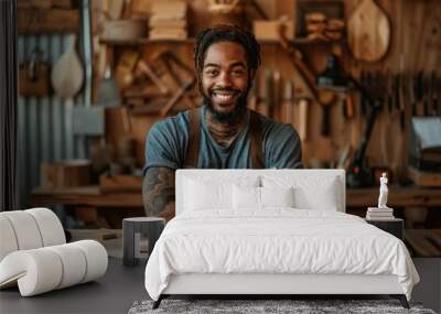 African American woodworker engaging with customers, Confident tattooed craftsman with crossed arms, dreads, and leather apron stands in a cluttered workshop. Wall mural