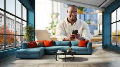 African business man, texting and phone in office with smile, connection and meme on social media app. Happy black businessman, typing and smartphone for networking, contact and reading blog on web Wall mural