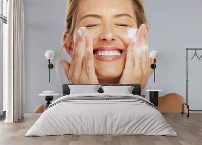 Face, cleaning and hygiene with a mature woman washing her skin in studio on a gray background. Skincare, healthcare and beauty with a female keeping her head clean, fresh and hygienic with a routine Wall mural