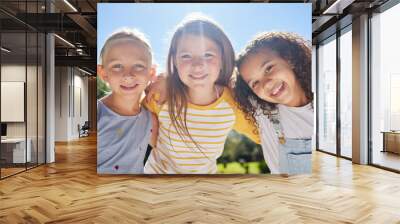 Happy, friendship and portrait of children in a park playing together outdoor in nature. Happiness, diversity and girl kid friends with smile standing, embracing and bonding in a outside green garden Wall mural