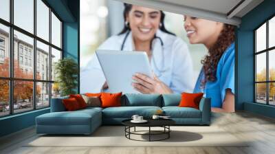 Hospital, doctors and women in discussion on tablet for medical analysis, research and internet. Healthcare, clinic and female health workers talking on digital tech for advice, consulting or service Wall mural