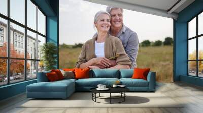 Love, hug and happy with old couple in nature for bonding, smile and romance. Happiness, retirement and support with senior man and woman in countryside for affectionate, holiday and vacation Wall mural