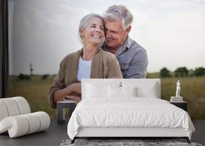 Love, hug and smile with old couple in nature for bonding, happy and romance. Happiness, retirement and support with senior man and woman in countryside for affectionate, holiday and vacation Wall mural