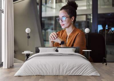 Night, research and report with a business woman working on a computer in her startup office at night. Thinking, idea and technology with a young female entrepreneur at work on a desktop in a company Wall mural