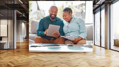 Technology, married couple with tablet and documents for pay their bills in a living room of their home. Finance or loan, budget or payment and black people with paper on a couch happy together Wall mural