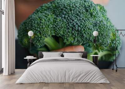 handsome young man holding a smoking broccoli Wall mural