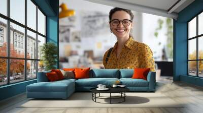 happy female business designer standing in an office smiling at work Wall mural