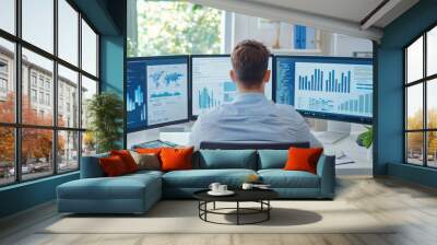 Businessman in a modern office analyzing e-commerce data with multiple screens displaying tracking information, data analysis, business strategy Wall mural