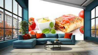 A savory pastry with tomato sauce, garnished with tomatoes and a side of dipping sauce. Wall mural