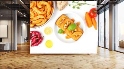 A white surface with a plate of fried food, orange slices, red peppers, and other ingredients. Wall mural