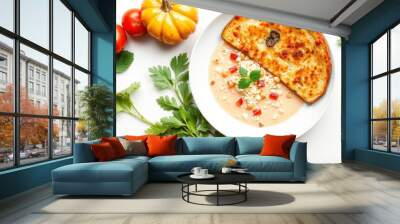 Creamy soup with chickpeas, red and yellow vegetables, and bread on a white background. Wall mural