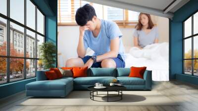 Asian young couple having problem of man worried impotent and unhappy at bedroom, trouble divorce of family with frustrated, husband having depression, conflict of love concept. Wall mural