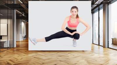 Beautiful portrait young asian woman fitness with stretching leg isolated on white background, asia girl workout with full body exercise and warm up, body care and healthy concept. Wall mural