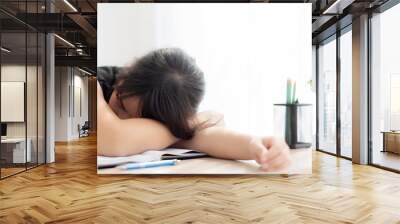 Beautiful portrait young asian woman learning exam or homework and sleep with tired and stress, lifestyle beauty asia girl having fatigue with work, education and business concept. Wall mural