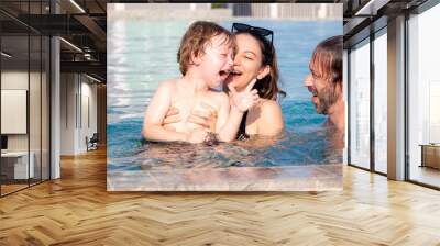 Caucasian family having enjoy and fun together with happiness in swimming pool, summer and holiday, mom, dad and son relax and playful, summertime and vacation, relation and bonding, family concept. Wall mural