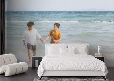 Homosexual portrait young asian couple running with cheerful together on beach in summer, asia gay going tourism for leisure and relax with happiness in vacation at sea, LGBT legal concept. Wall mural