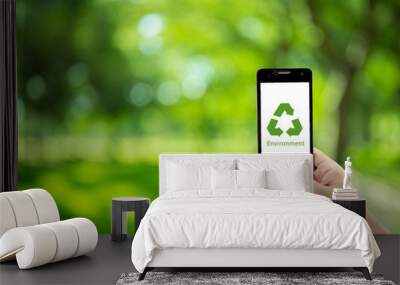 mobile phone holding hand with recycle symbol eco environment icon concept Wall mural