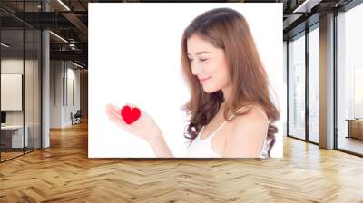 Portrait of beautiful asian young woman holding red heart shape pillow and smile isolated on white background, valentines day, holiday concept. Wall mural