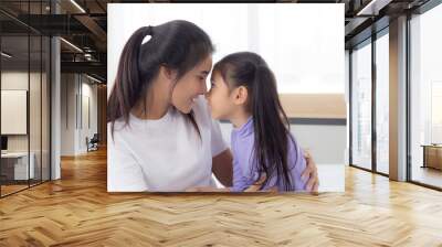 Young asian mother and daughter hug and touching nose on face with tender together, mom and girl with happy for relationship and bonding, feeling and emotion, parent and child, family concept. Wall mural