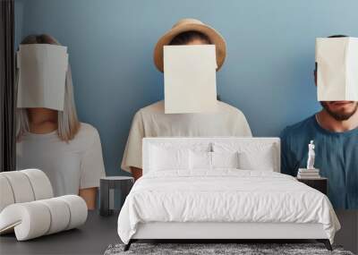 three people stand side by side with blank papers covering their faces against a blue background, an Wall mural