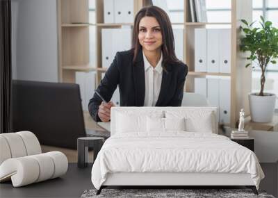 Business woman writes in notebook, office, workplace. Wall mural