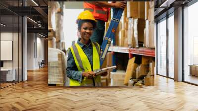 Portrait of female staff standing with arms crossed in warehouse, Industrial and industrial workers concept. Wall mural