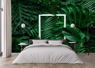 tropical green leaves and palms with white paper note frame, nature flat lay concept Wall mural