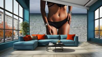 Close-up of an ideal fitness body of a luxurious girl on the beach, sexy black bikini, perfect bronze tan skin, Fashionable silver accessories,  low key photo, Radiant skin, Fashion glamor, life style Wall mural