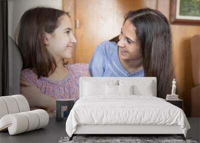 Two girls playing with a tablet Wall mural