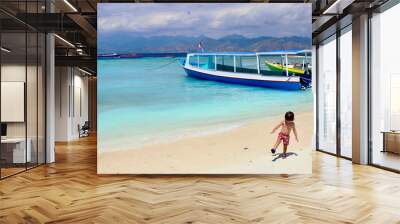 Two years old cute little kid enjoying his time in the sand somewhere between Surf Point beach and  Harbor beach in Gili Trawangan island, on of the most impressive spots in Lombok, Indonesia. Wall mural