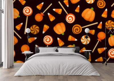 Vector seamless pattern with orange Halloween candies on a black background.  Wall mural