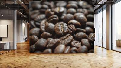 The image shows a close-up of dark, roasted coffee beans. One bean is in focus, highlighting its natural seam. The rest are blurred, creating a rich, textured background.

 Wall mural