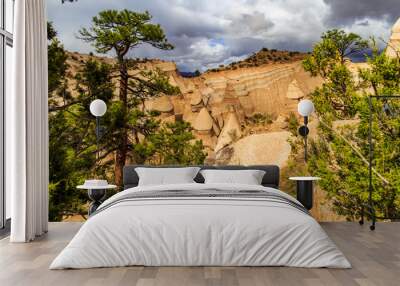 Landscape of rock formations against dark stormy sky in Kasha-Katuwe Tent Rocks National Monument in New Mexico, USA Wall mural