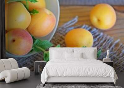 Delicious,sweet apricots and a sprig of mint on the burlap. Wall mural