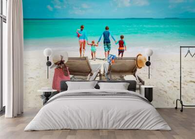 chairs and happy family with kids having vacation at beach Wall mural